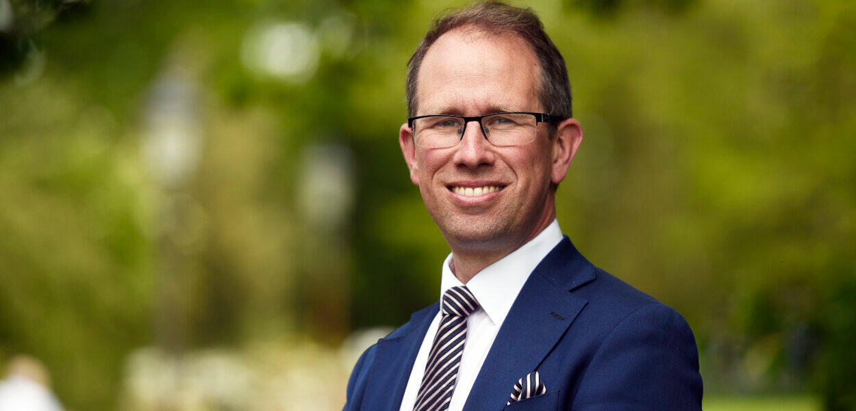 Police and Crime Commissioner, Matthew Barber, stood outside against a backdrop of trees