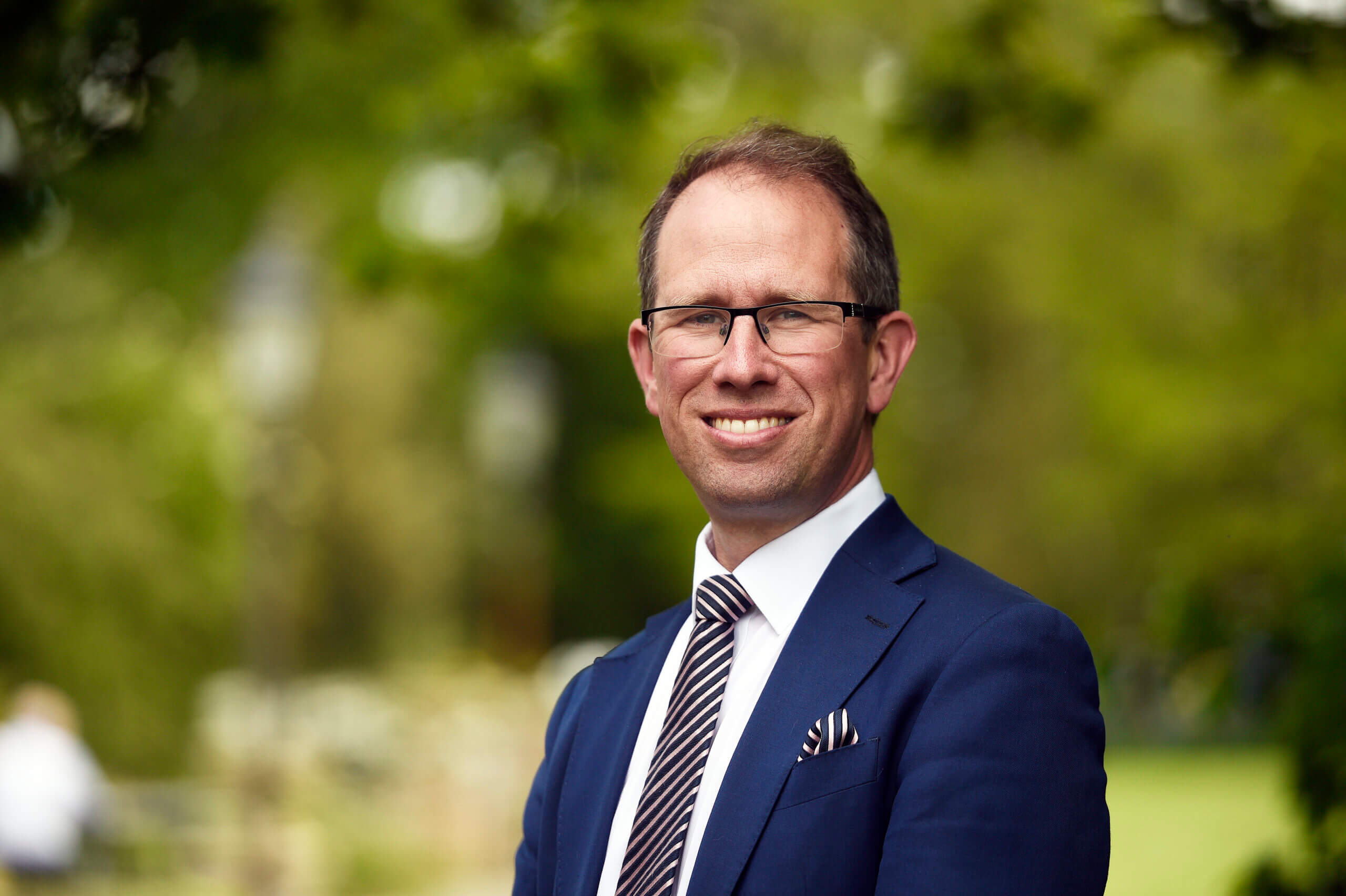 Police and Crime Commissioner, Matthew Barber, stood outside against a backdrop of trees