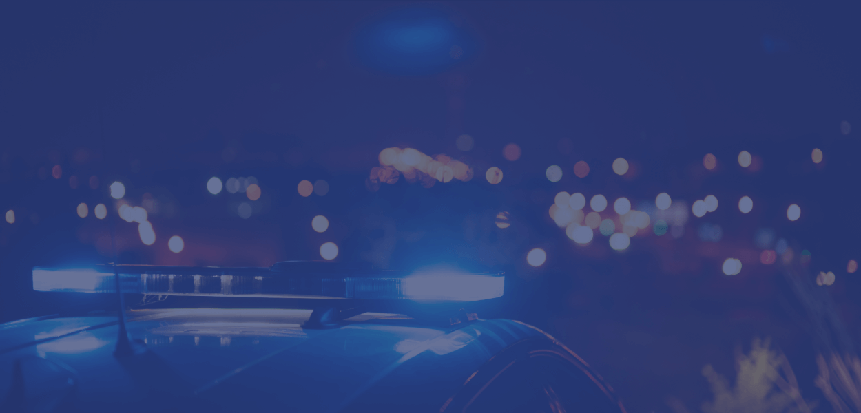 Image of police car siren lights on blue background